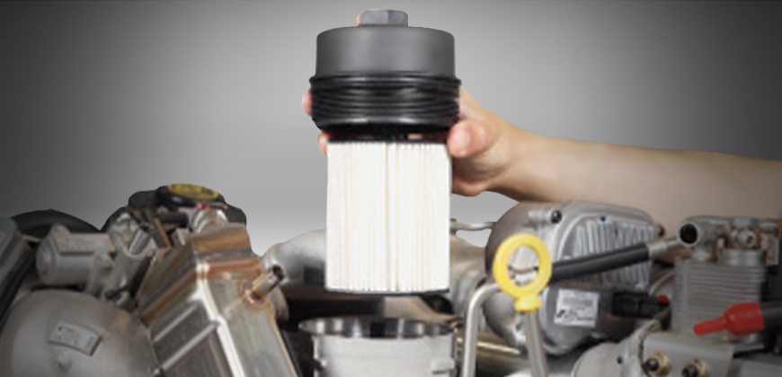 A mechanic installing a fuel filter in a Power Stroke Diesel engine.