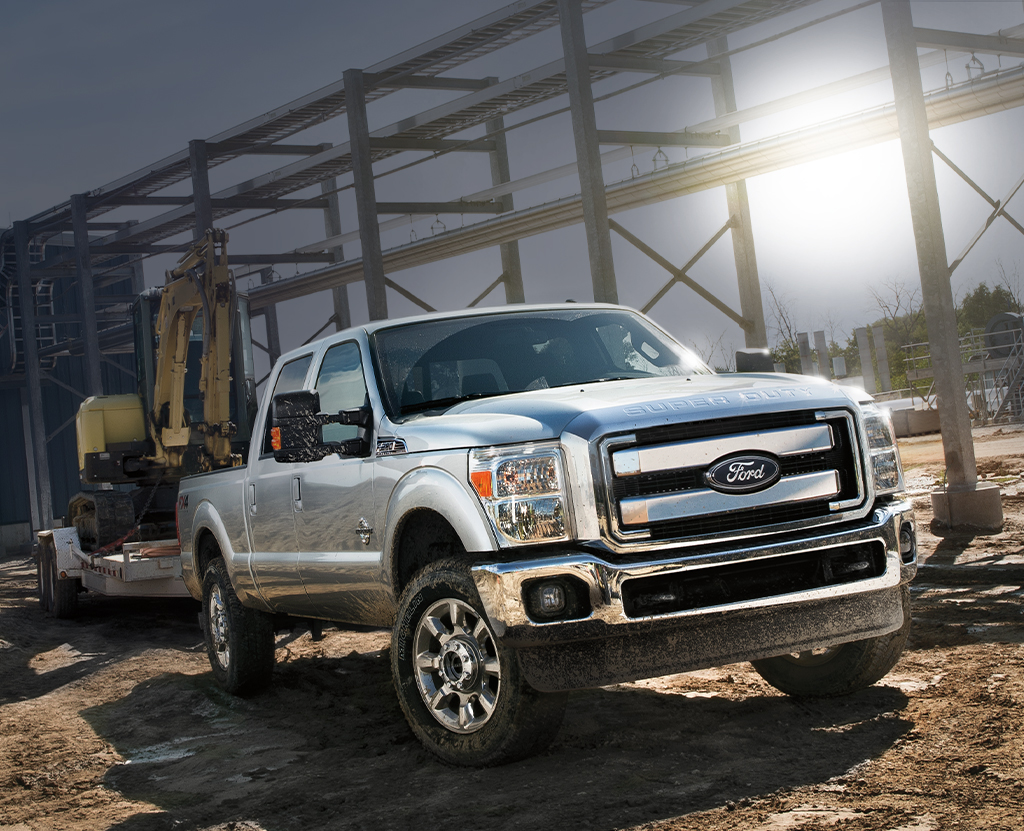 A Ford Super Duty truck hauls construction equipment.