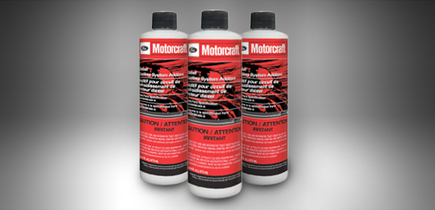 Motorcraft coolant additives displayed on a clean table.