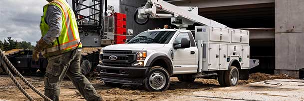 A Ford Utility Body truck is hard at work.