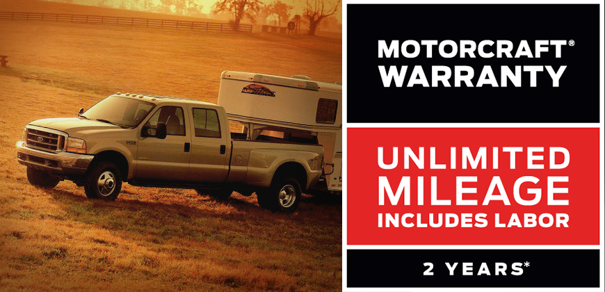 The Motorcraft Warranty logo displayed over an image of a Ford pickup, pulling a camping trailer.